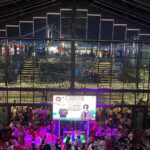 A vibrant night view inside Millac The Market at Night filled with crowds and neon lights overlooking Gwangan Bridge