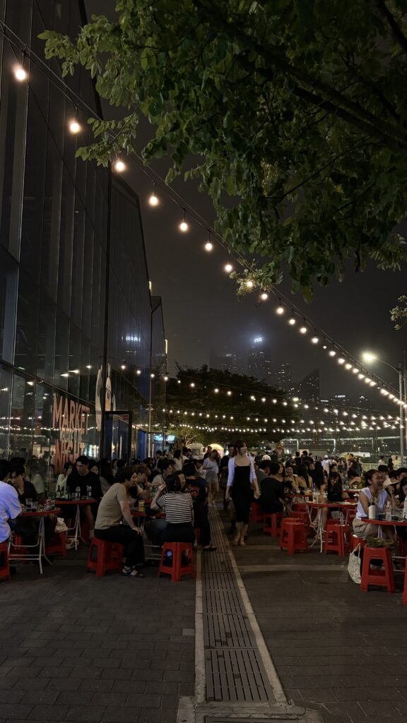 Crowded outdoor seating area with string lights during Market Night at Millac The Market at Night