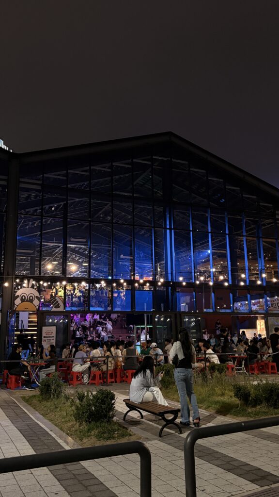 Visitors lined up outdoors waiting to enter Millac The Market at Night