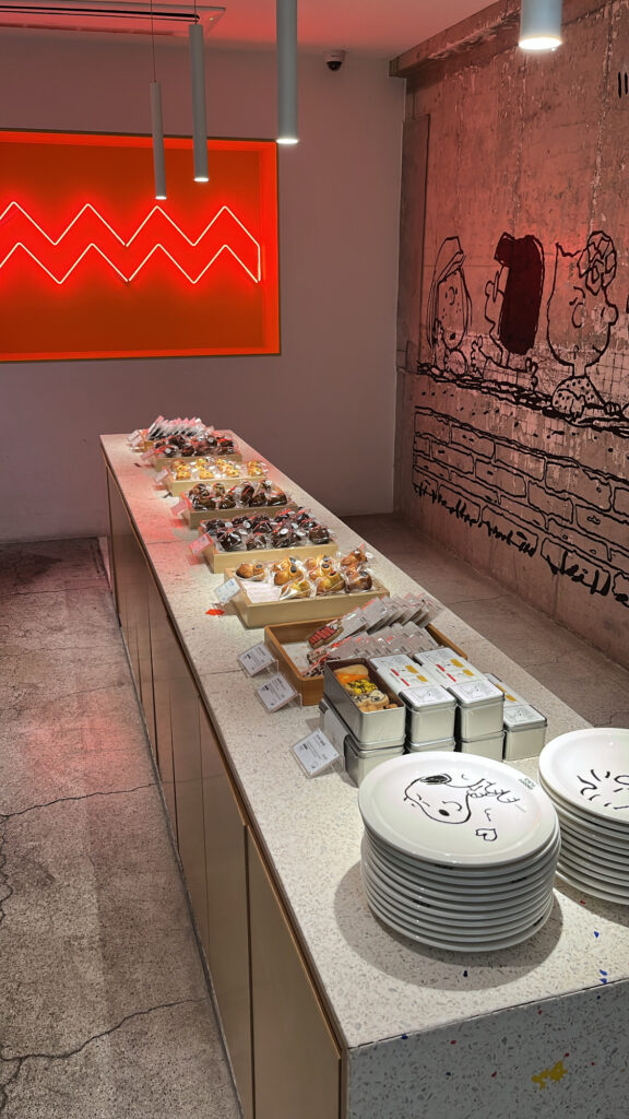 Freshly baked pastry and dessert display at Snoopy Place Busan bakery section