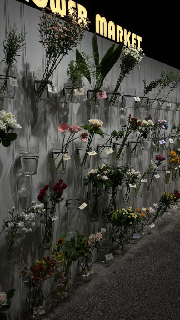 Aesthetic Flower Market wall display with fresh flowers inside Millac The Market at Night