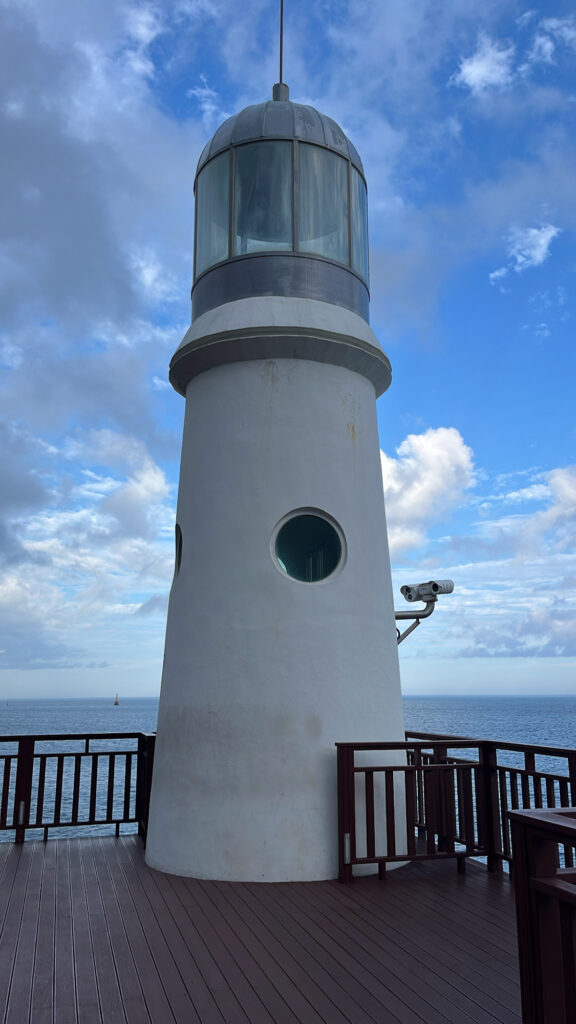 White Dongbaekseom Lighthouse standing on the coastal rocks