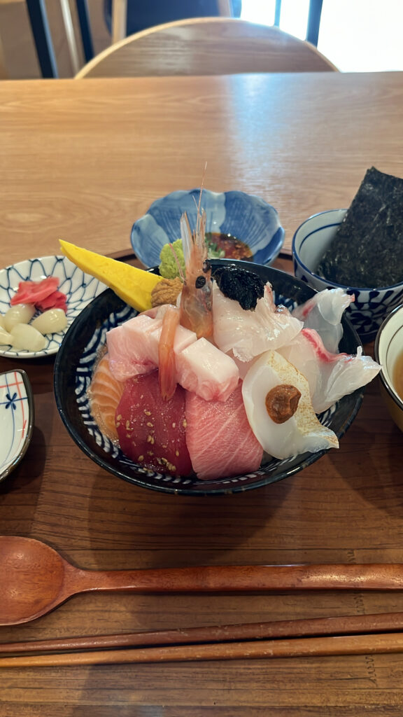 Close up of fresh seafood rice bowl topped with sashimi