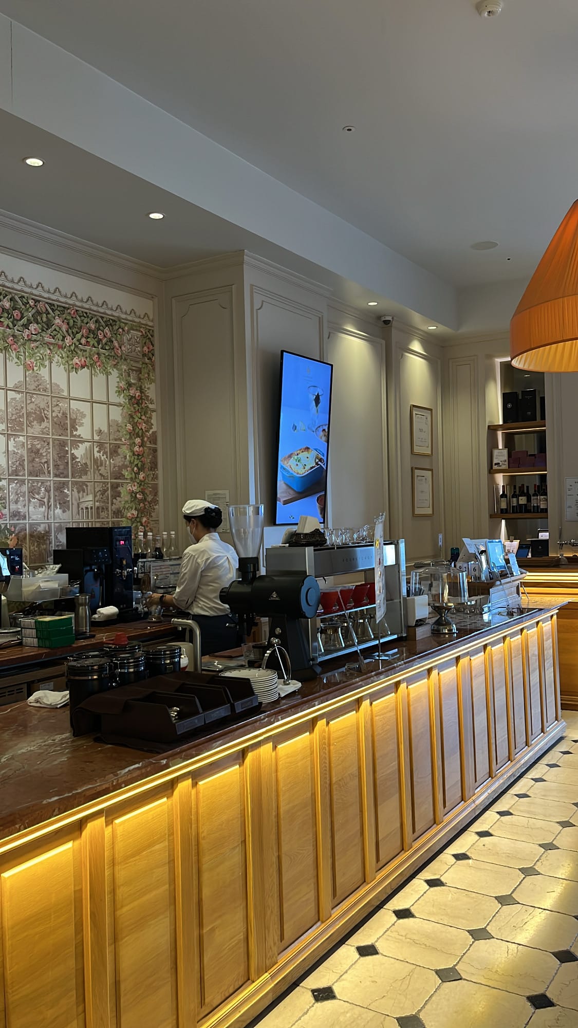 Elegant espresso and beverage bar counter at De Marigny French cafe