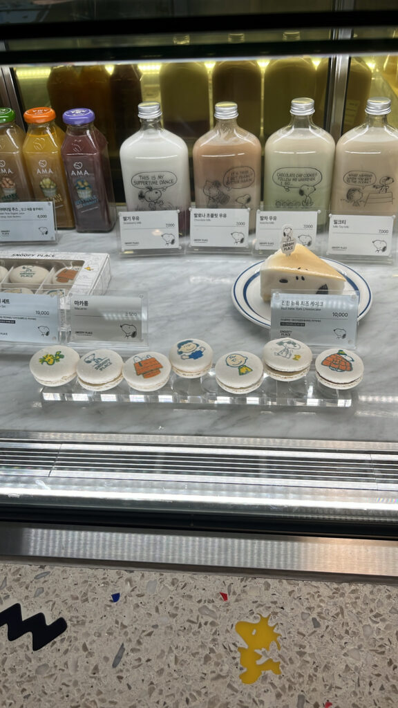 Selection of cute character desserts and bottled drinks at Haeundae Snoopy Cafe