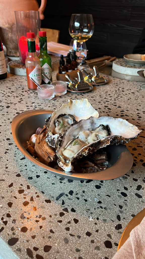 Fresh oysters served with Tabasco sauce and wine pairing at Moment Local Busan