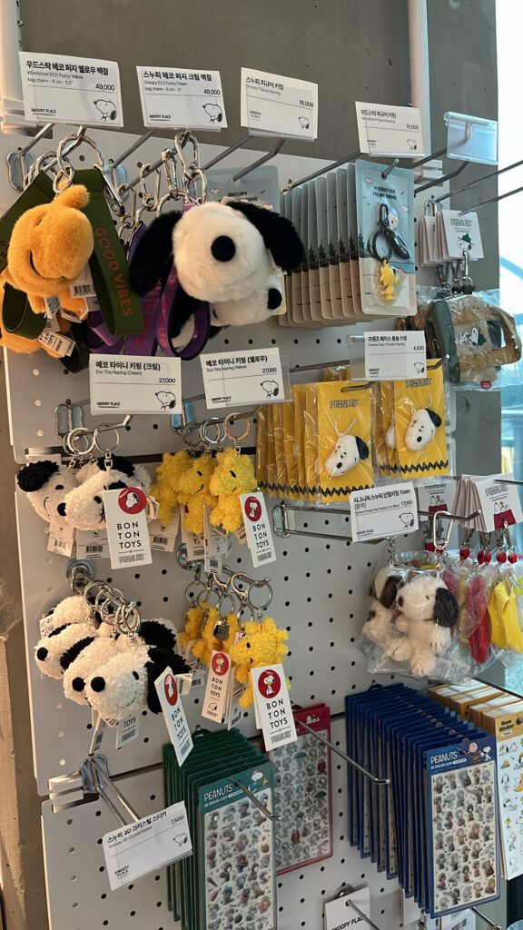 Various Peanuts character plushies and souvenirs displayed at Snoopy Place Busan