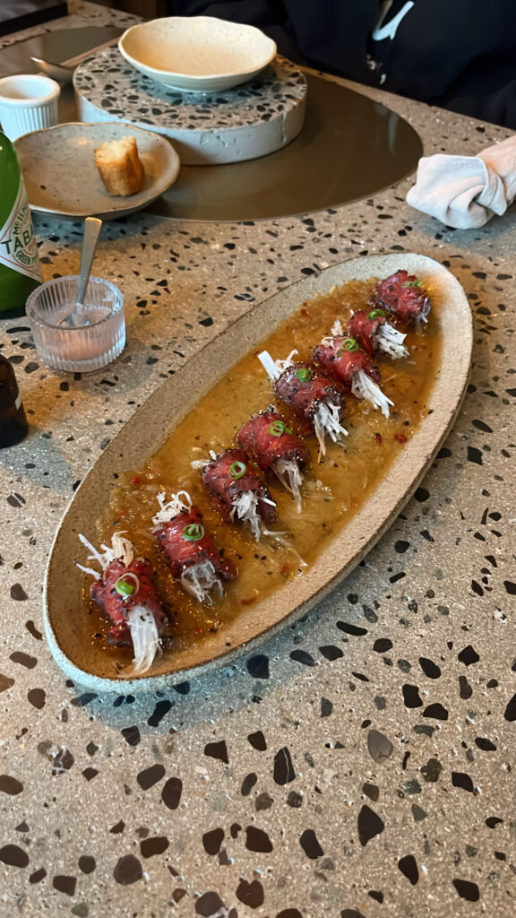 Artfully rolled Korean Hanwoo beef carpaccio dish at Moment Local Busan