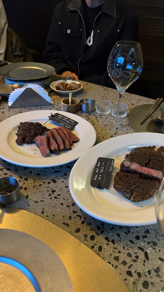 Perfectly grilled 1++ Hanwoo steak plates with wine at Moment Local Busan