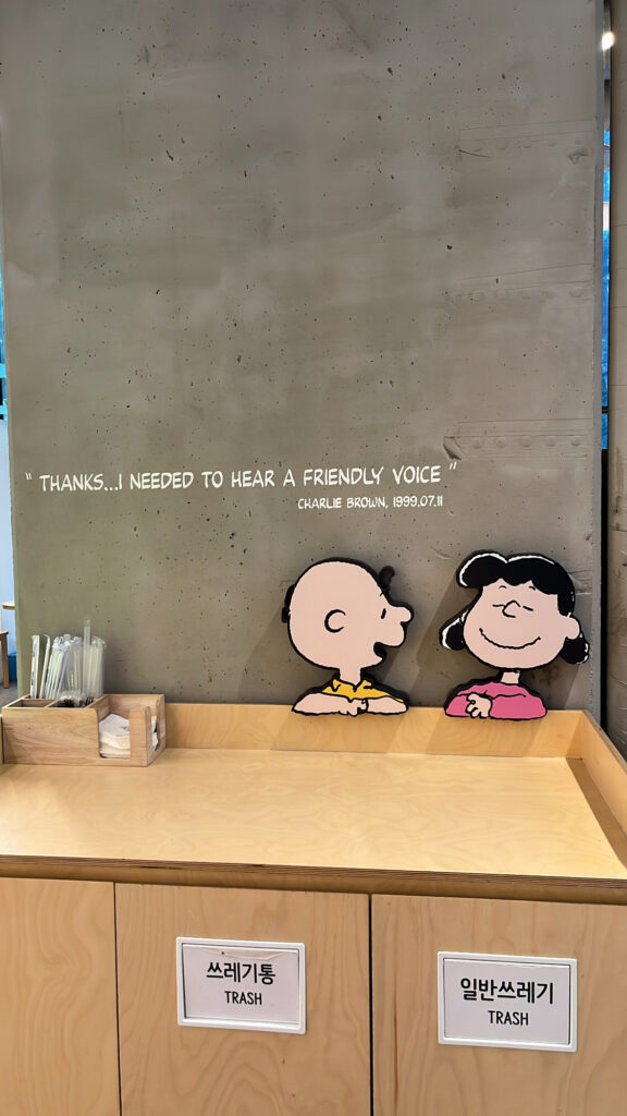 Cute return counter with Peanuts character illustrations at Snoopy Place Busan