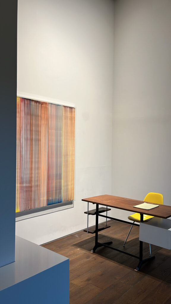 Private exhibition room with modern desk, yellow chair, and artwork at Johyun Gallery Busan