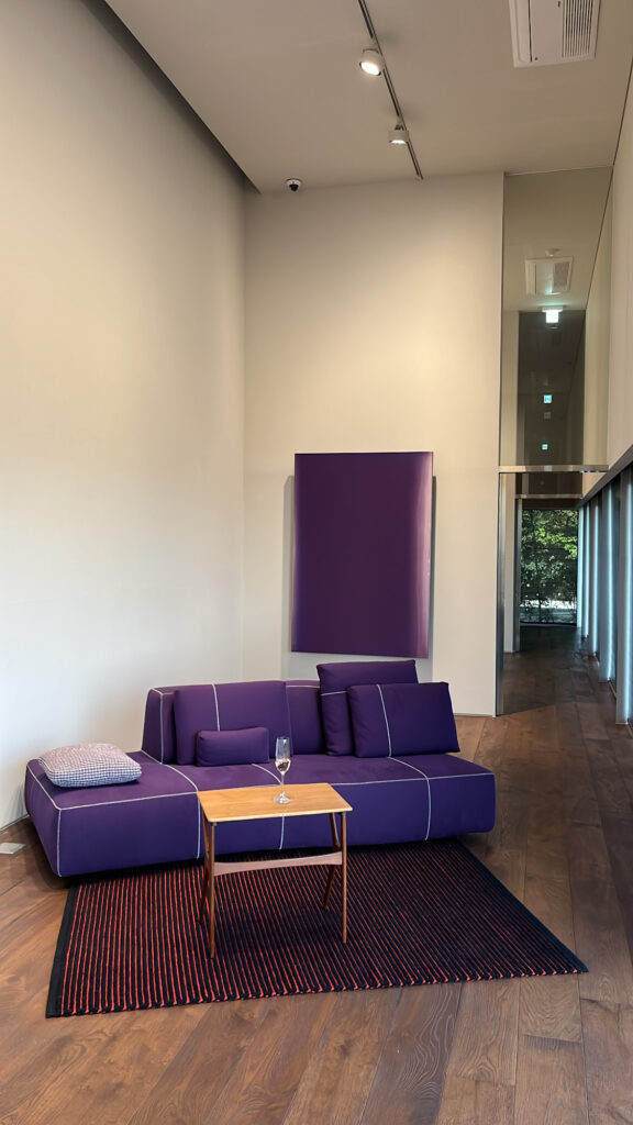Relaxing lounge space with purple sofa and modern interior at Johyun Gallery Busan
