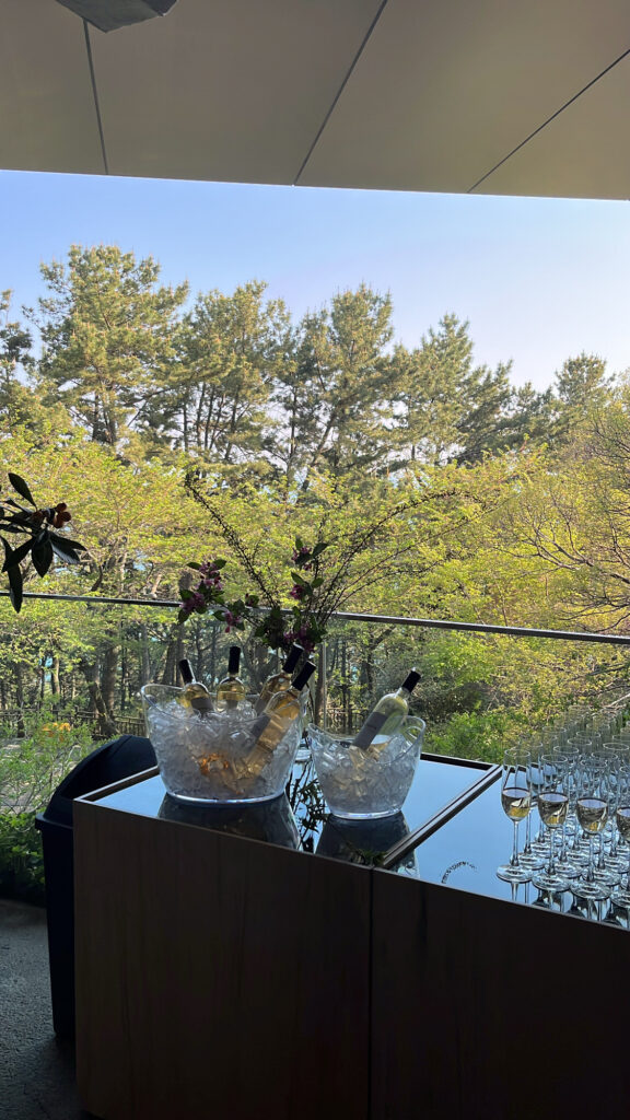 Event wine reception setup with ocean and forest views at Johyun Gallery Busan