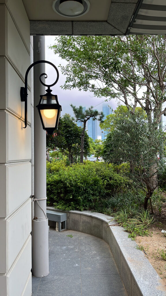 De Marigny Busan exterior pathway with view of LCT in the distance