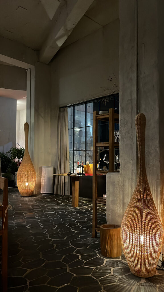 Warm night interior ambiance with rattan standing lamps at Moment Local Busan