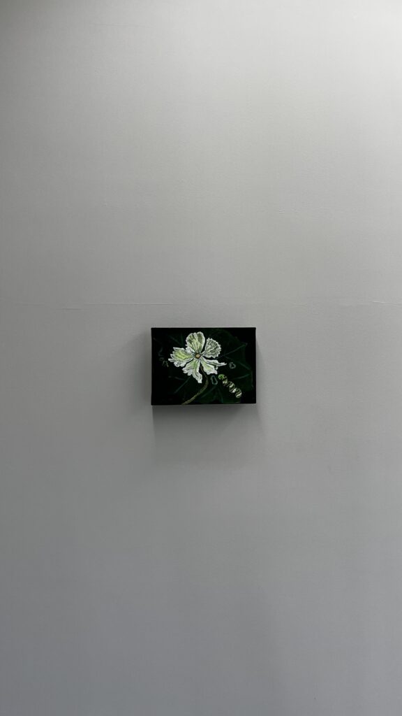 Small framed flower painting displayed on minimalist white wall at Johyun Gallery Busan