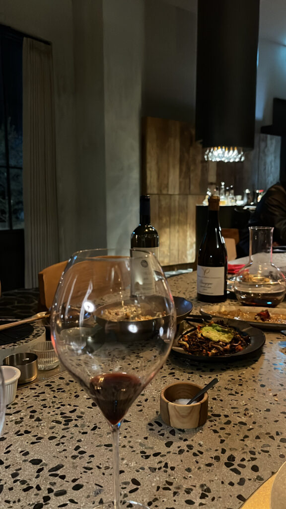 Red wine glass on the terrazzo table with dim night lighting at Moment Local Busan