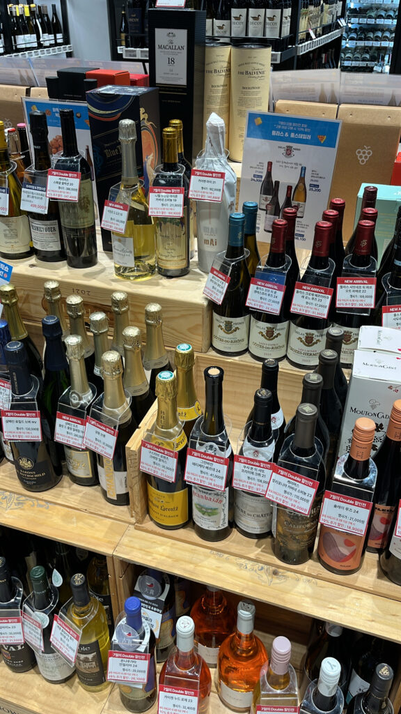 Discounted and promotional wine bottles displayed on the center racks at WINE PICKS