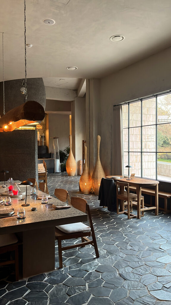 Atmospheric interior seating and large window view at Moment Local Busan dining bar
