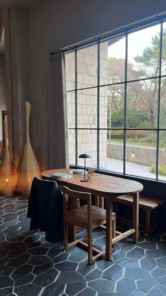 Cozy window table setting with natural lighting at Moment Local Busan