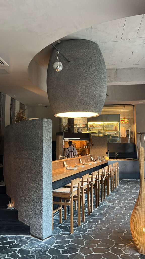 Stylish bar counter seating with modern pendant lighting at Moment Local Busan