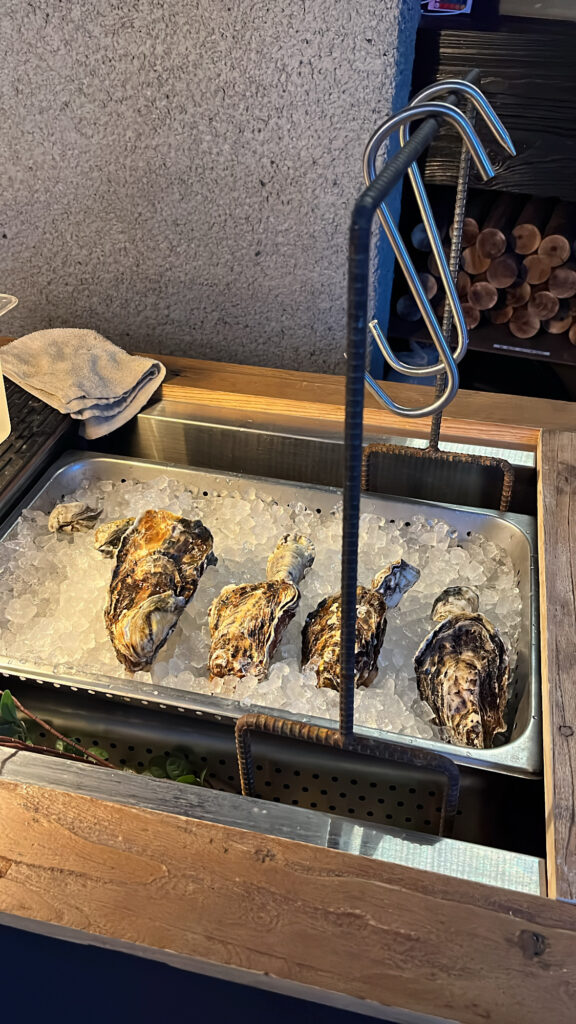 Fresh triploid oyster display on ice at Moment Local Busan oyster dining bar