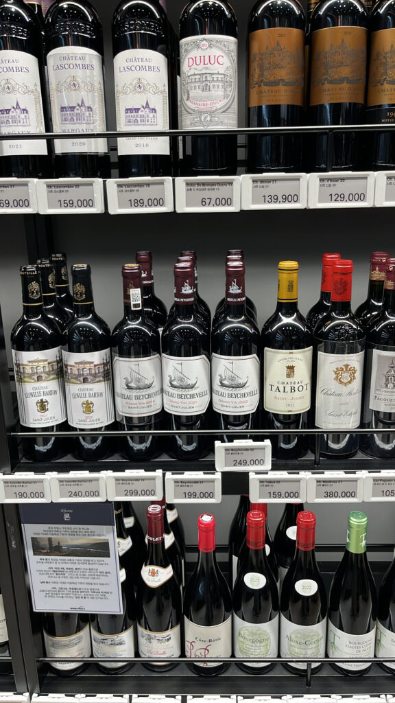 Premium Bordeaux red wines on display with price tags