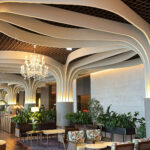Luxurious seating and ocean view interior with elegant chandeliers at McQueen's Lounge Busan