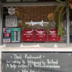 Exterior entrance and chalkboard menu sign of Pili Pili Busan