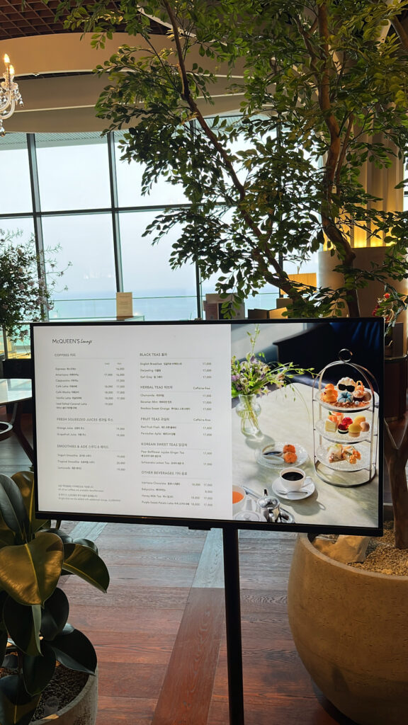 Menu board stand at the entrance of McQueen's Lounge Busan