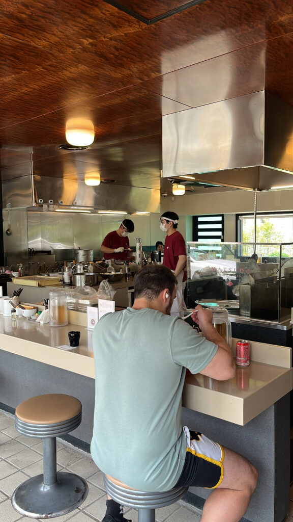 Cozy Japanese noodle bar interior and counter seating at Matsudo Busan
