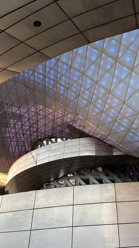 Dramatic underside view of the giant cantilever LED ceiling at Busan Cinema Center