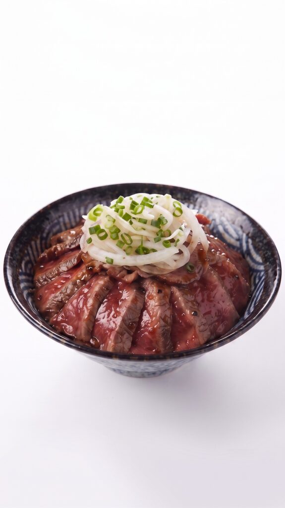 Signature medium-rare steak donburi topped with sliced onions and sauce