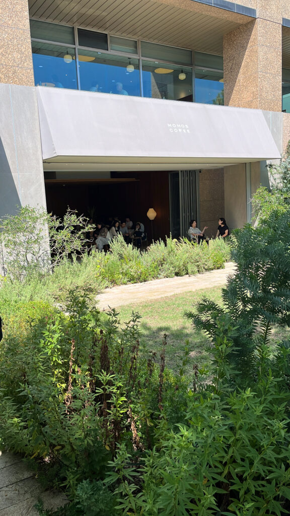 Modern building facade and natural landscape garden at Momos Coffee Marine City