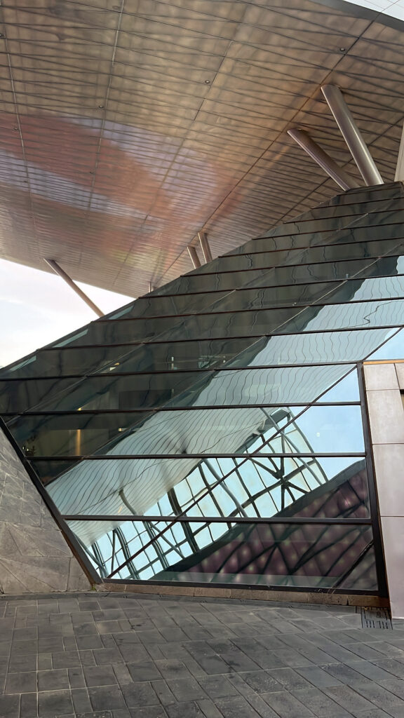 Futuristic glass windows and modern interior staircase leading up to the library