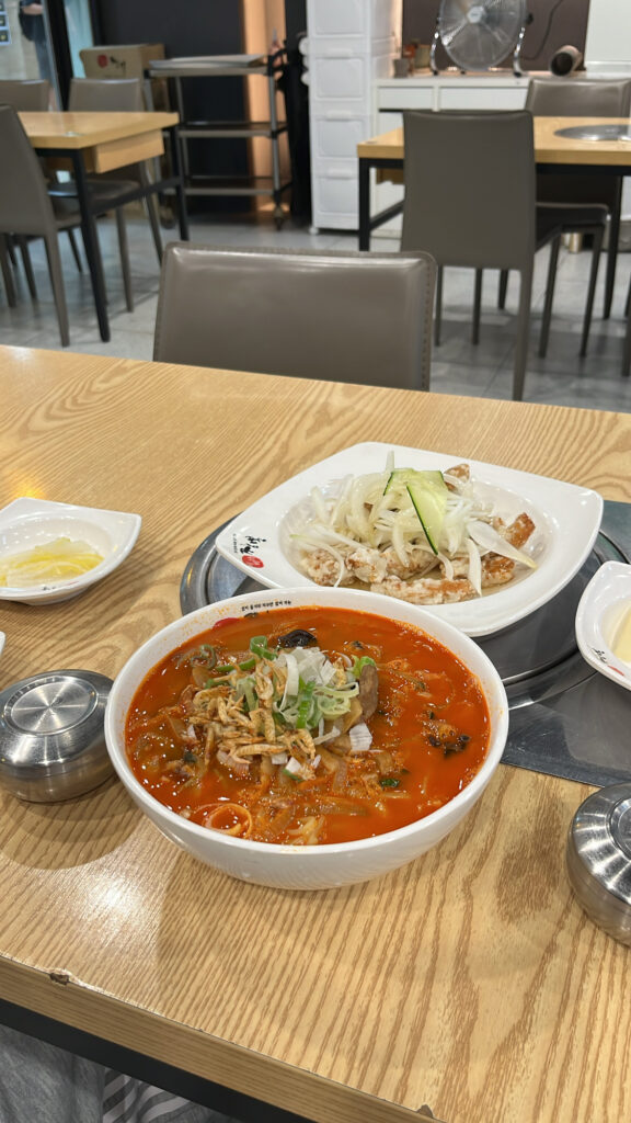 Table setup with signature Ebiga spicy seafood noodle soup and crispy sweet and sour pork