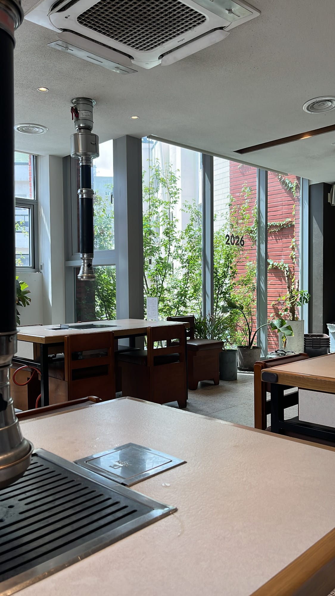 Spacious second-floor dining area with wooden tables at Gohasoon Gwangalli
