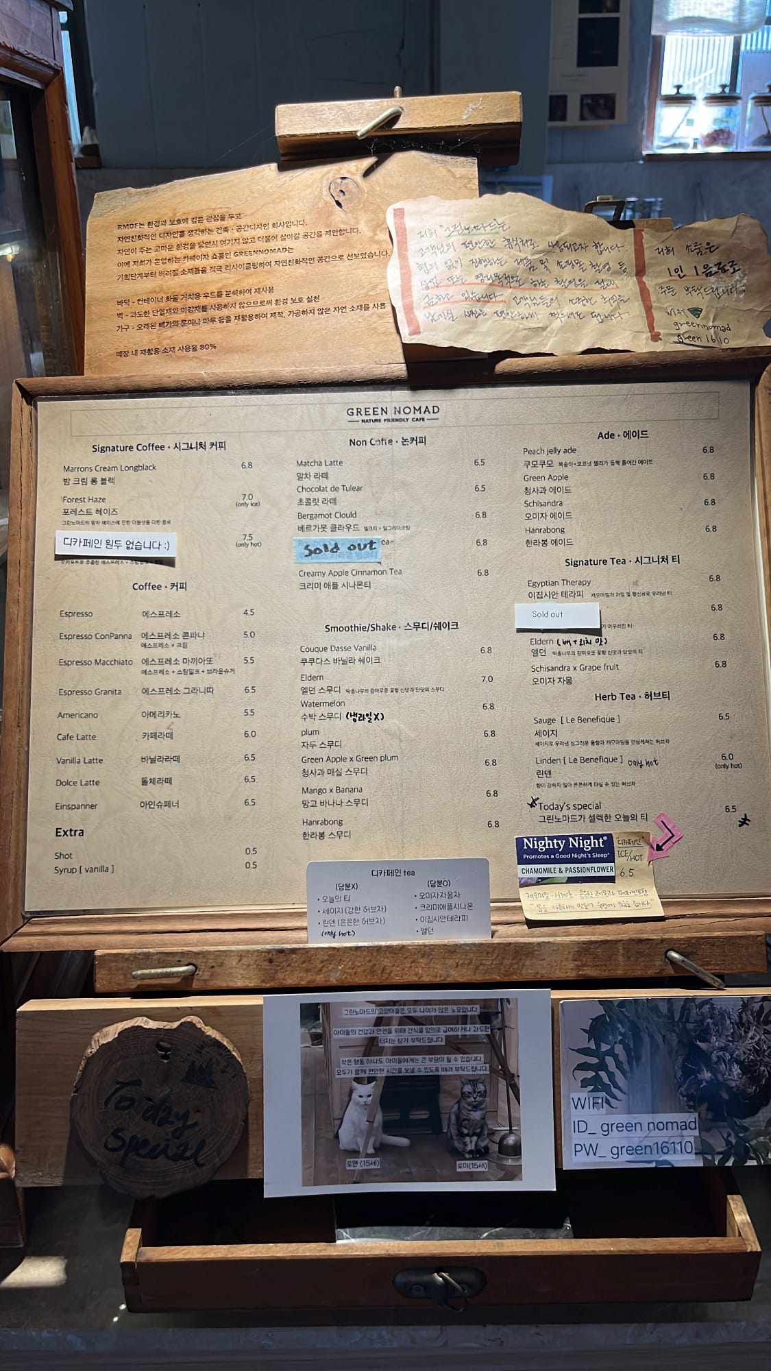 Full drink and dessert menu board placed at the counter of Green Nomad Busan cafe
