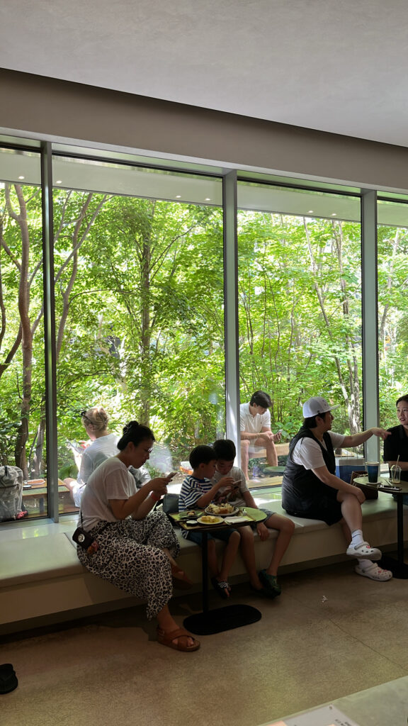 Guests sitting by large glass windows at Momos Coffee Marine City in Busan