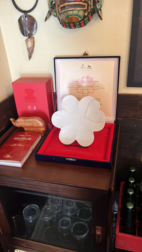 Official Michelin Guide Busan selection plaque displayed inside Pili Pili