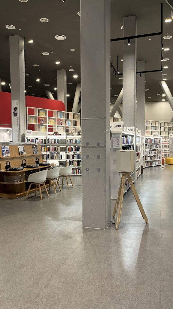 Spacious interior reading hall and high ceiling structure at Busan Cinema Center Library