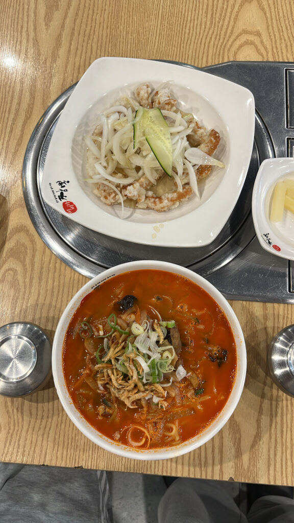 Top-down flat lay view of red spicy seafood jjamppong and white tangsuyuk set meal