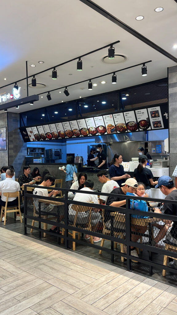 Busy seating area in the B1 food court near Hongdae Gaemi Centum City