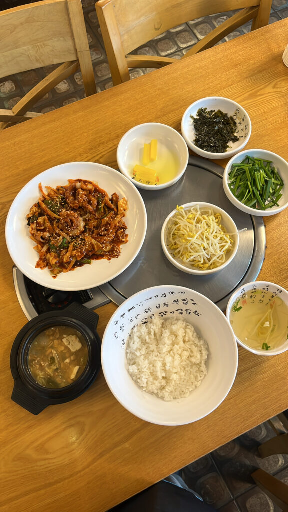 Full table setting for Busan octopus rice bowl with Cheonggukjang stew