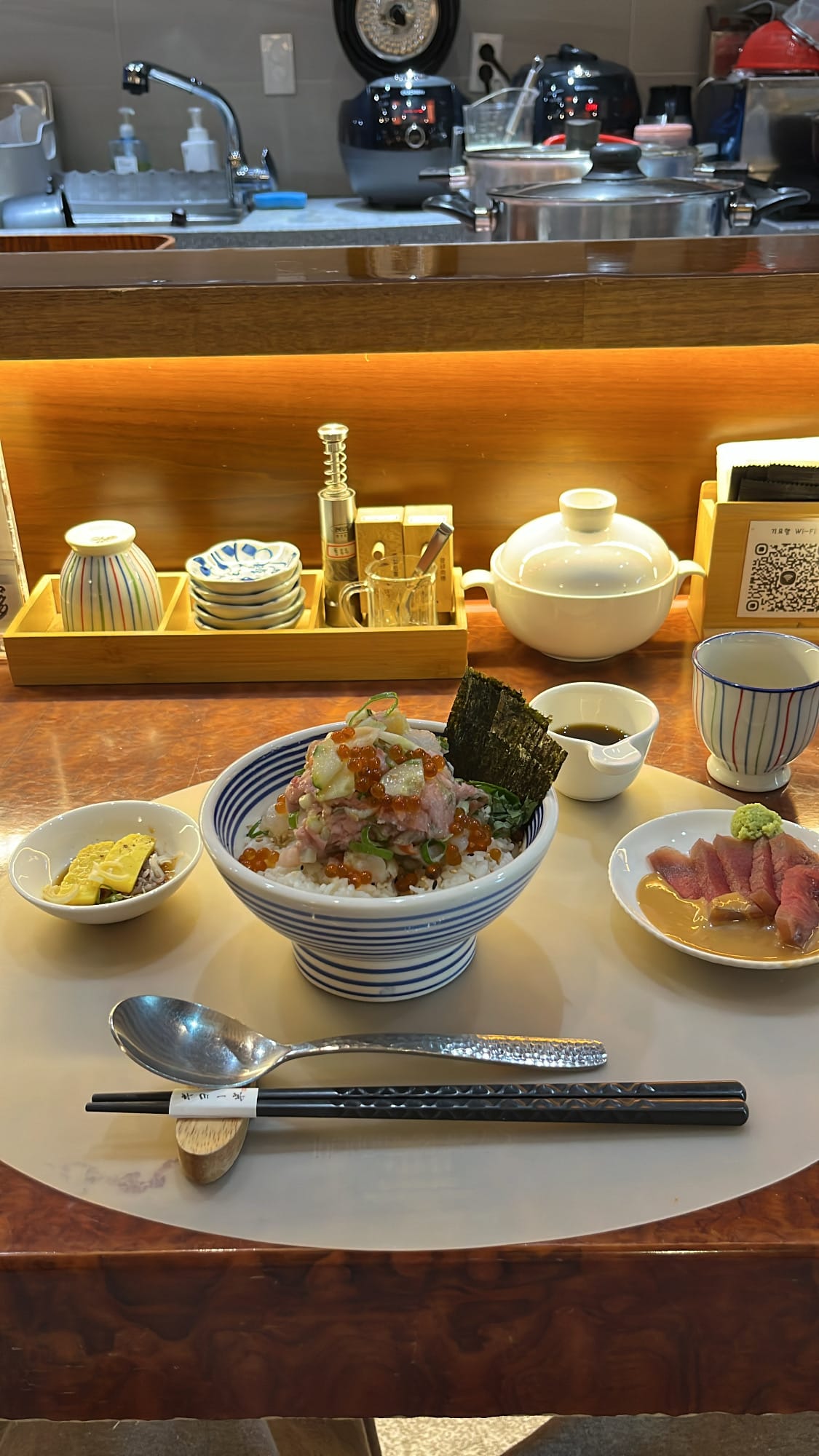 Full table setting with the served signature Giyohang Kaisendon seafood bowl