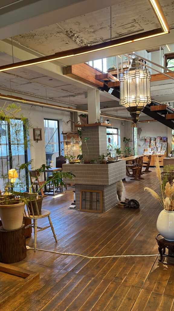 Vintage wooden staircase leading up to the 2nd floor seating area at Green Nomad Busan