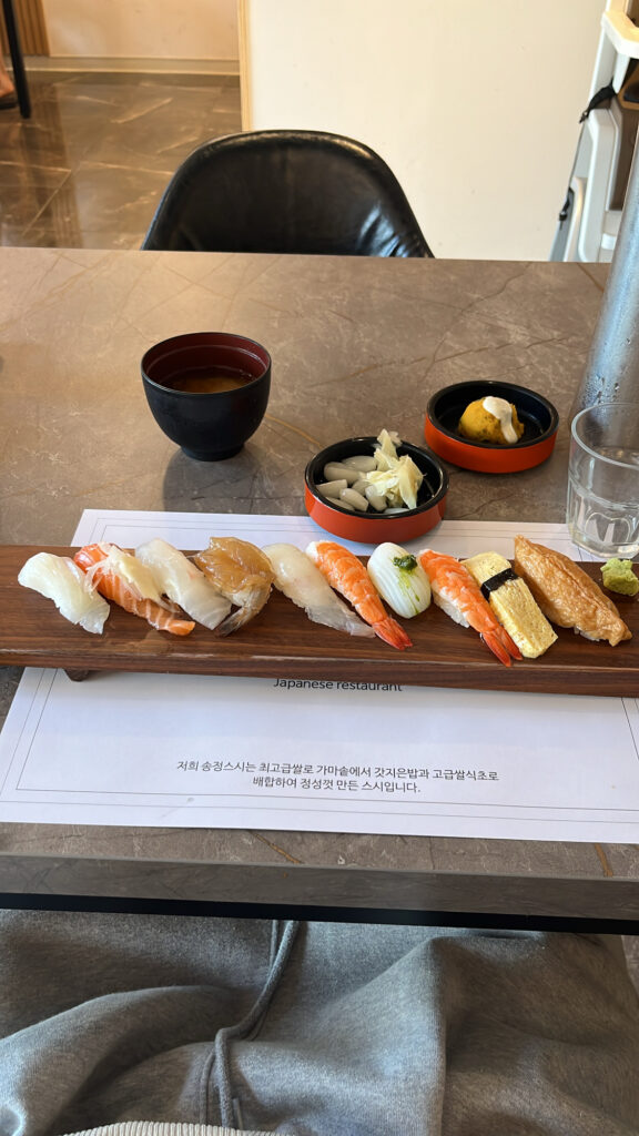 Fresh assorted Sushi Set A served on a wooden platter at Songjeong Sushi Busan