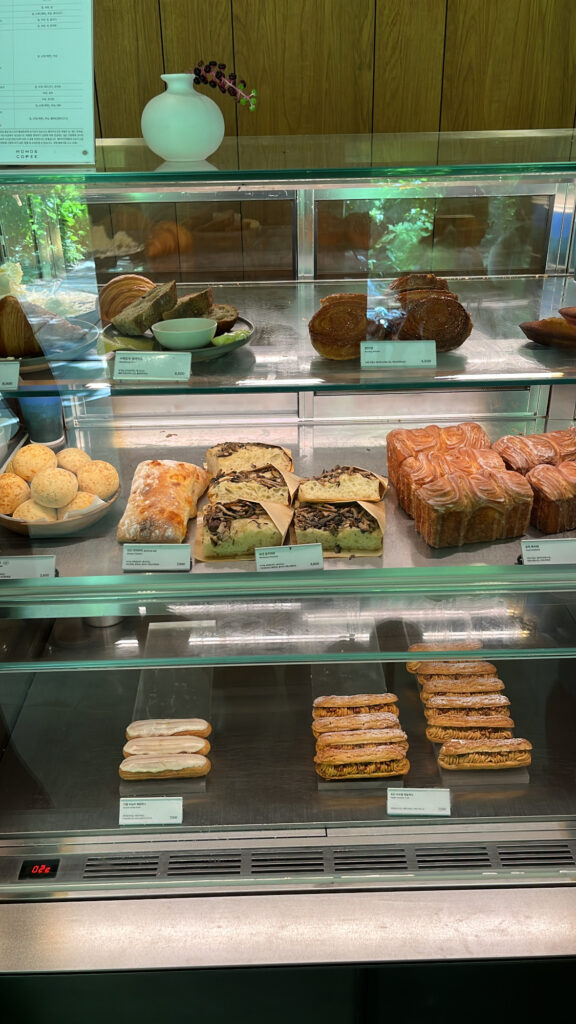 Freshly baked financiers and pastry display case at Momos Coffee Marine City