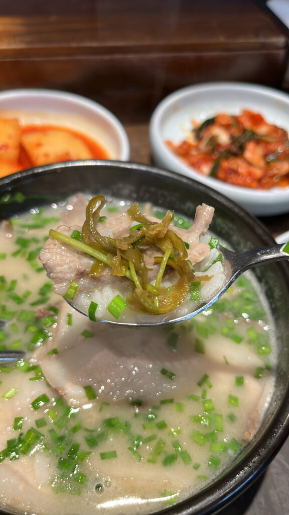 Korean side dishes including pickled peppers served with pork soup