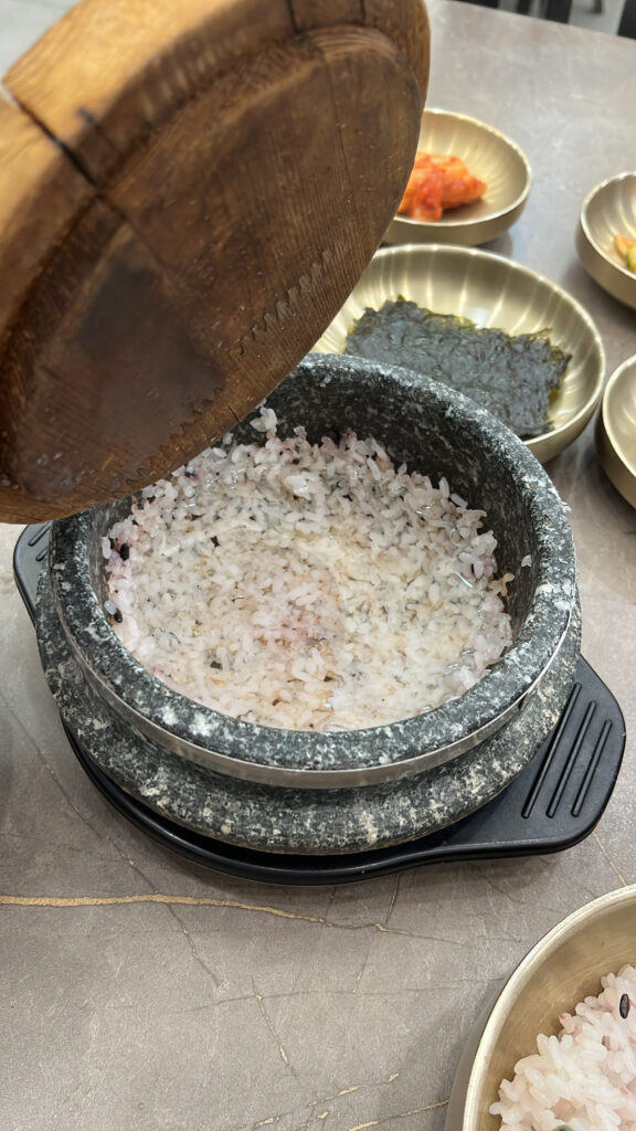 Pouring hot water into stone pot to make traditional Korean scorched rice tea